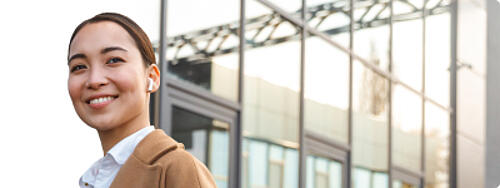 Person standing outdoors near office buildings for Statista+ Research Solutions